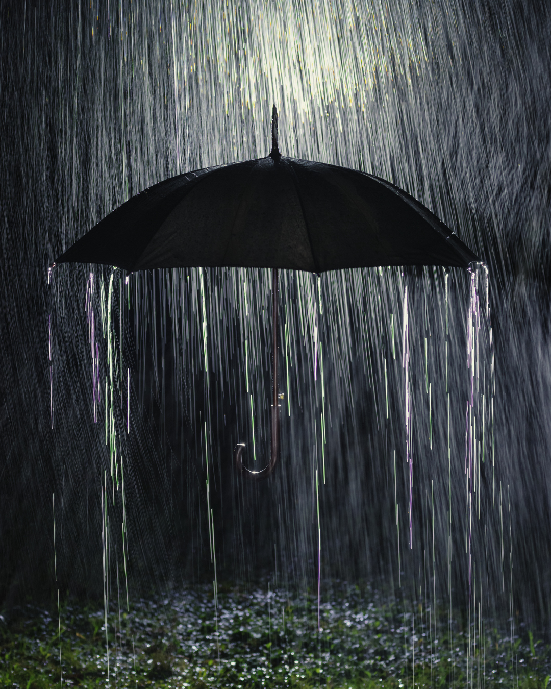 Heavy rain falling on an umbrella symbolizes storm damage challenges handled by True North.