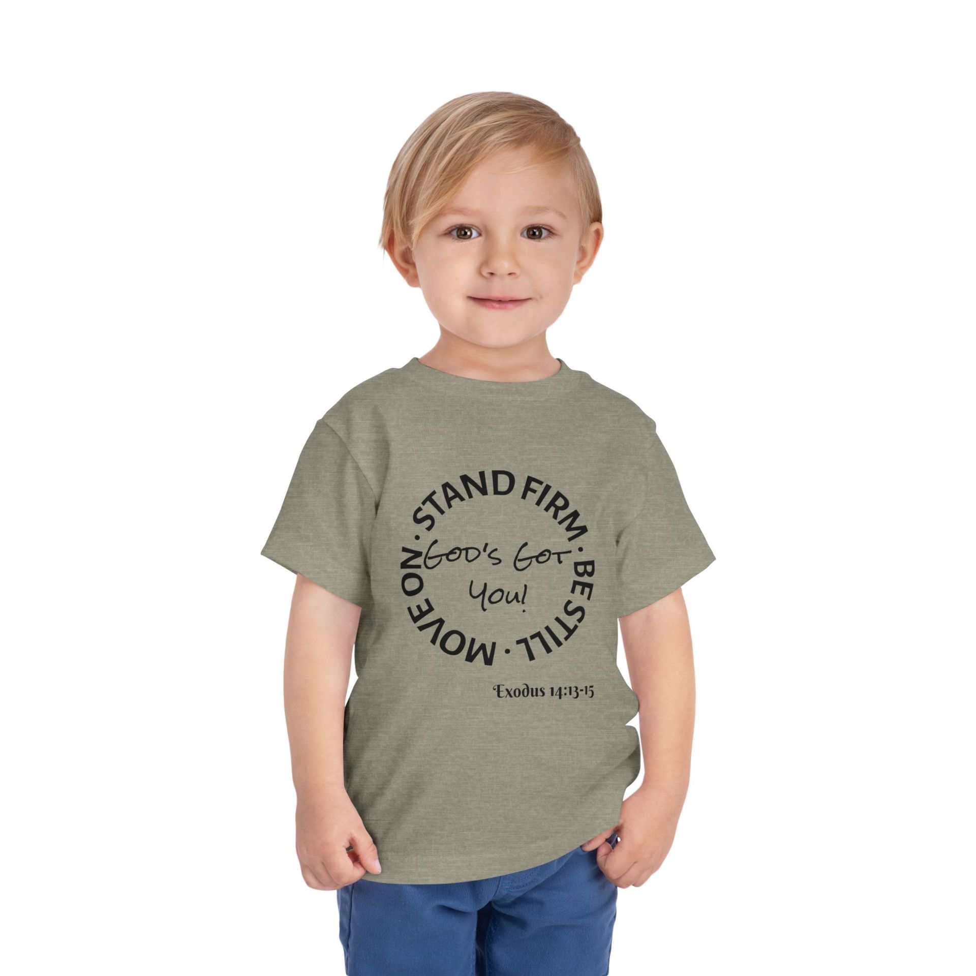 Toddler wearing a green shirt with the text 