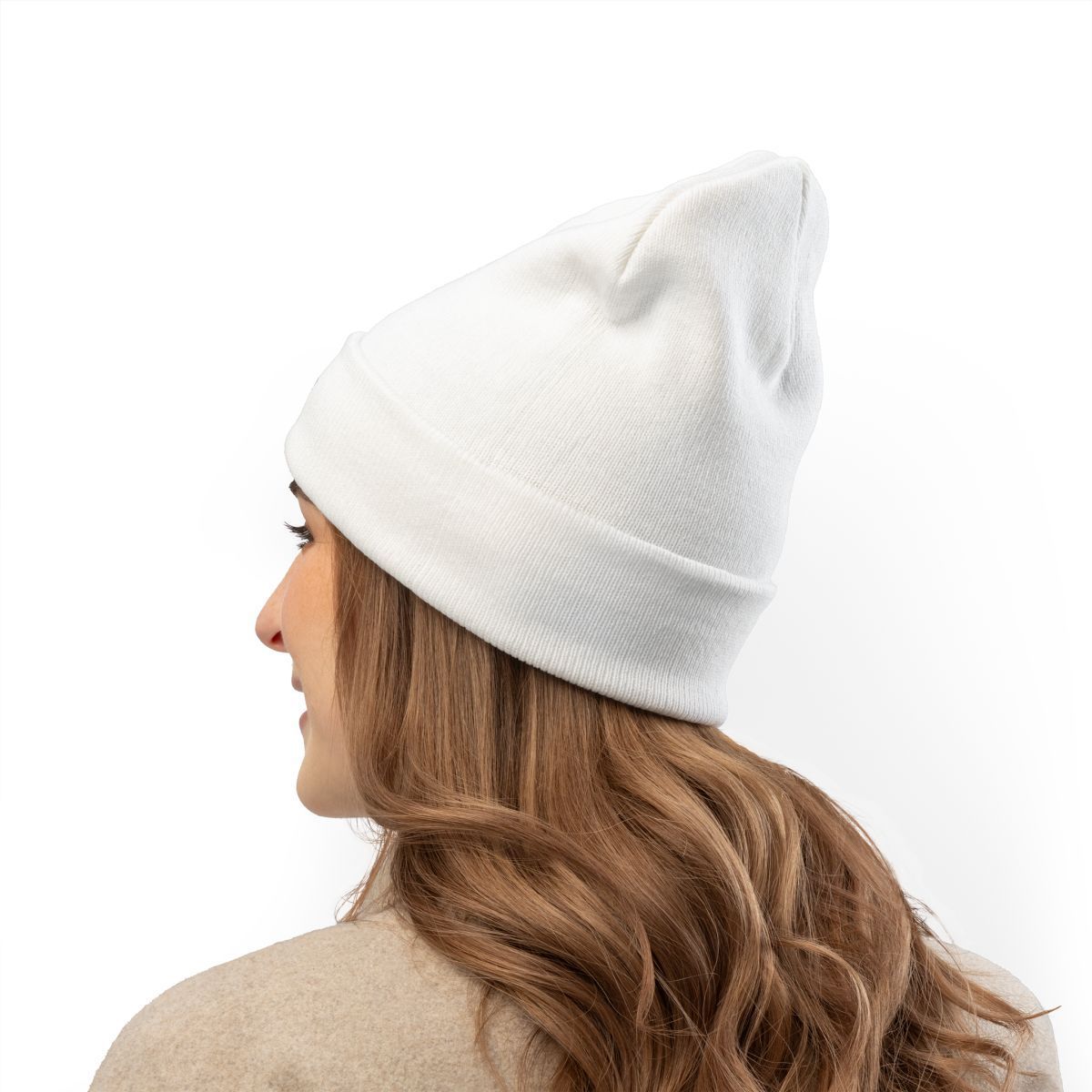 Woman wearing a white beanie, side view, against a white background.