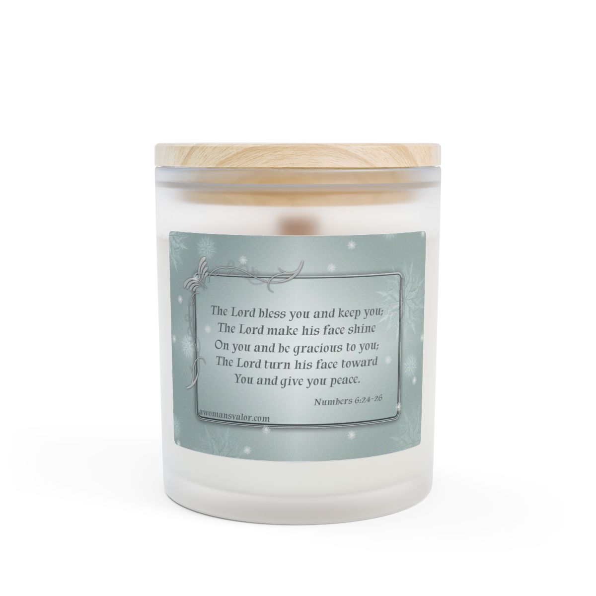 White candle with a wooden lid, light blue label with a Bible verse, set against a white background.