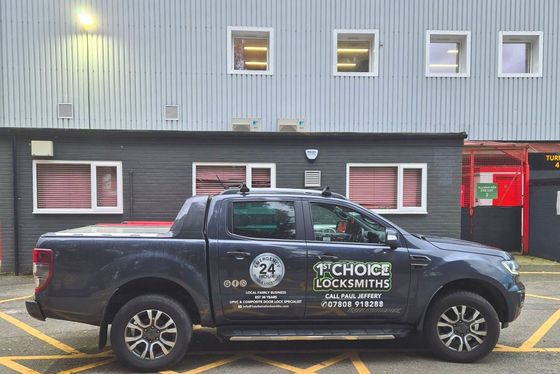 A van 1st choice Oswestry Locksmiths is parked in front of a building .