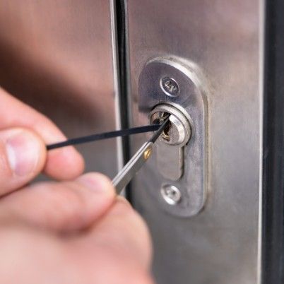 Oswestry Locksmiths using a picks to open a door lock.