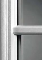 Close-up of a white window frame with a horizontal bar dividing the glass panes.