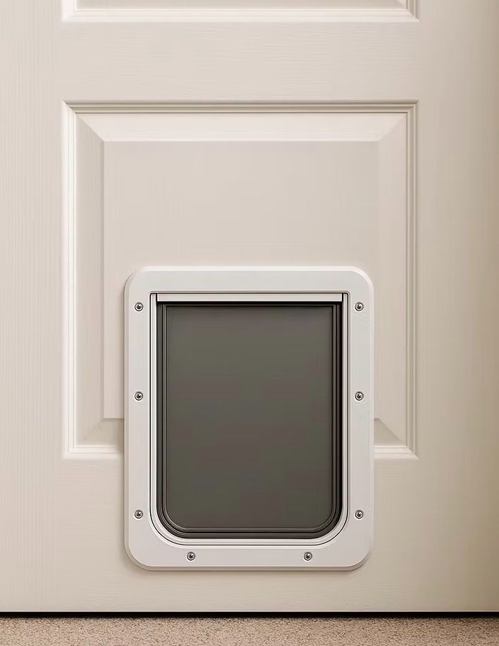 White pet door installed in a white paneled door.
