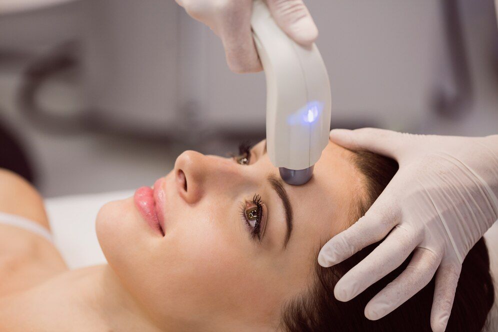 A woman is getting a facial treatment at a beauty salon.