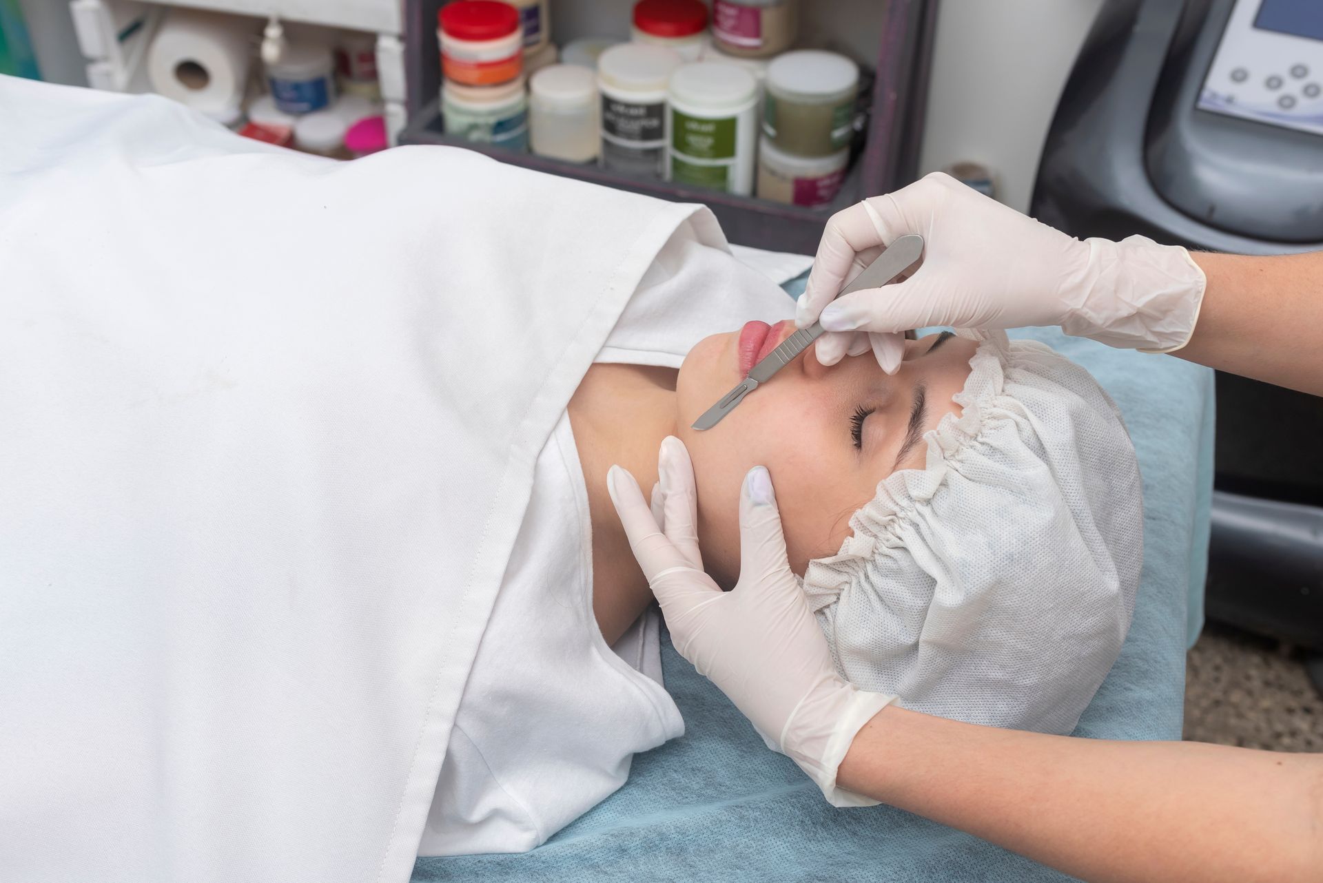 A woman is getting a facial treatment at a beauty salon.