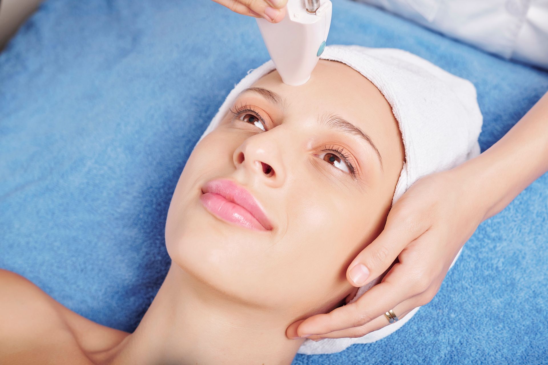 A woman is getting a facial treatment at a spa