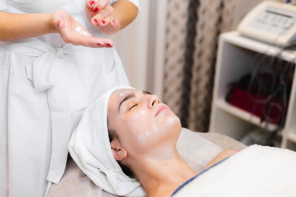 A woman is getting a facial treatment in a beauty salon.