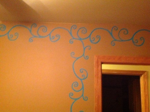 A wall with blue swirls painted on it