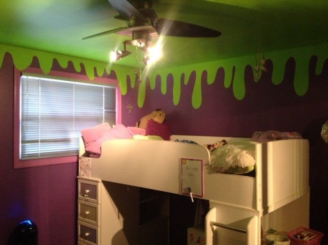 A purple and green room with a bunk bed and a ceiling fan