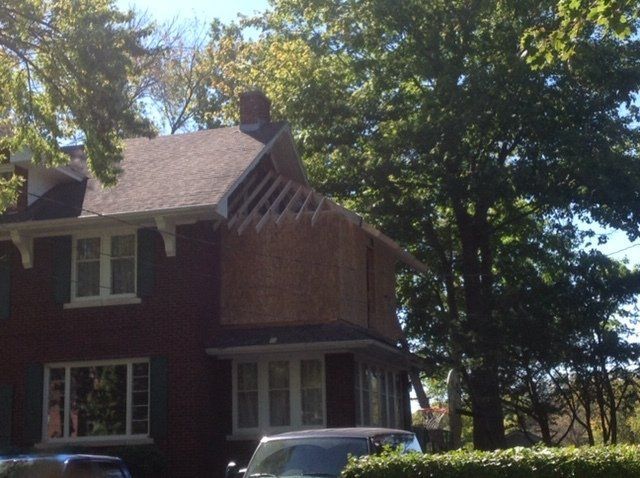 A brick house with a car parked in front of it
