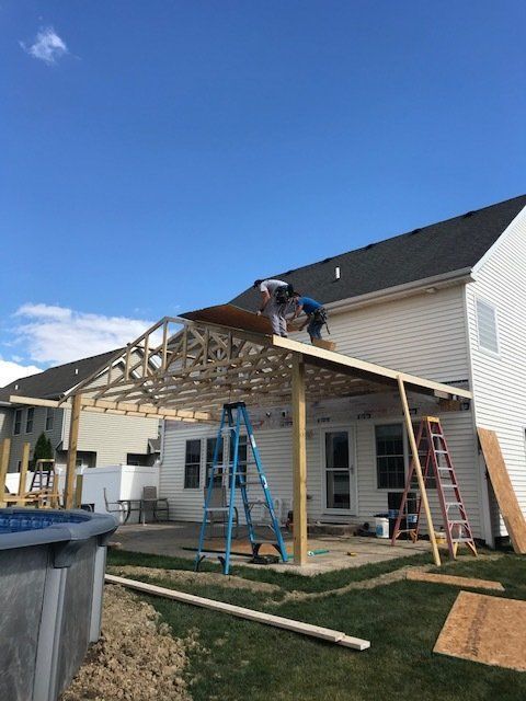 A man is working on the roof of a house.