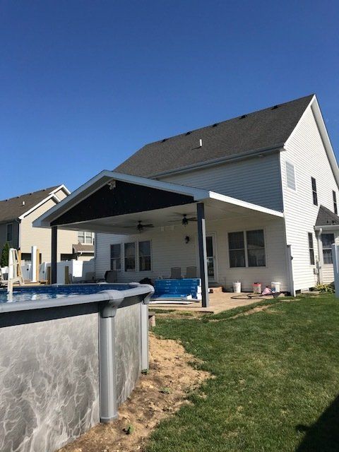A large white house with a pool in front of it