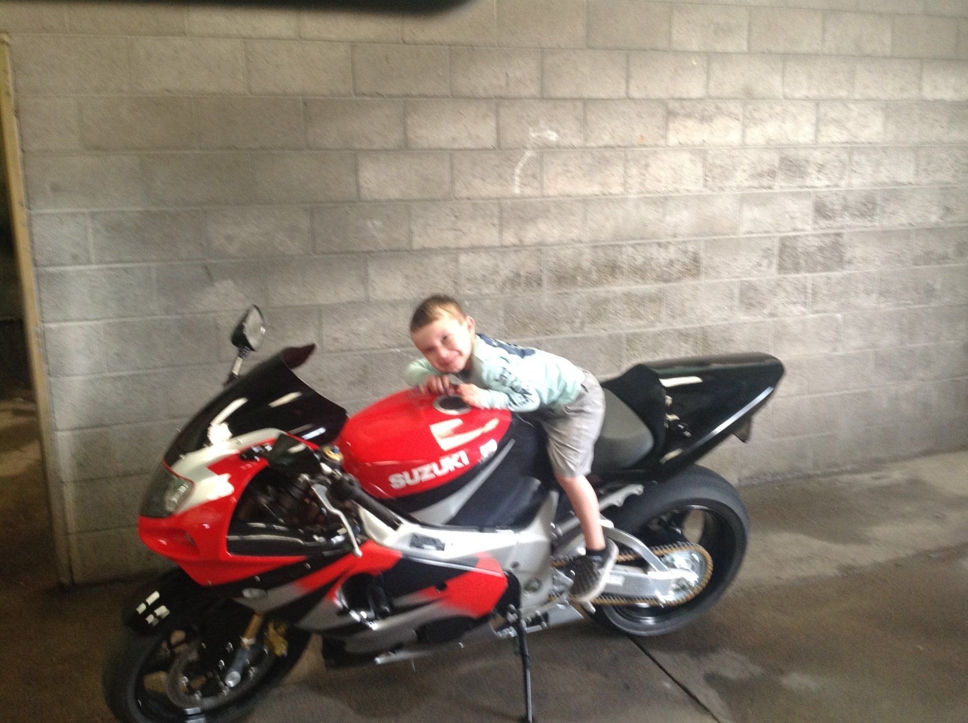 Red Big Bike with Kid — Sparks, NV — Sam’s Sparkle Shop