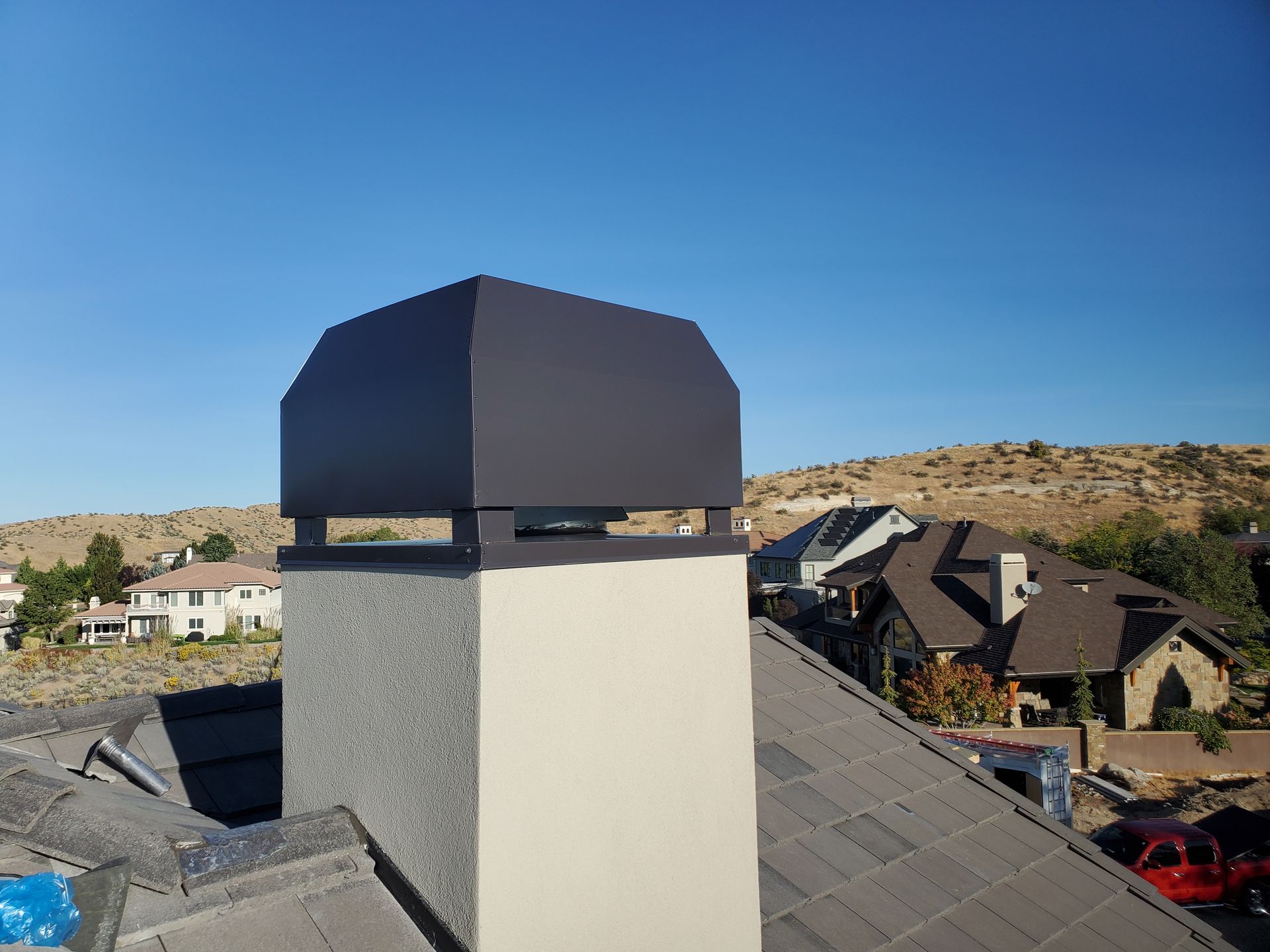 Silver HVAC ducting in attic with insulation and wooden supports.