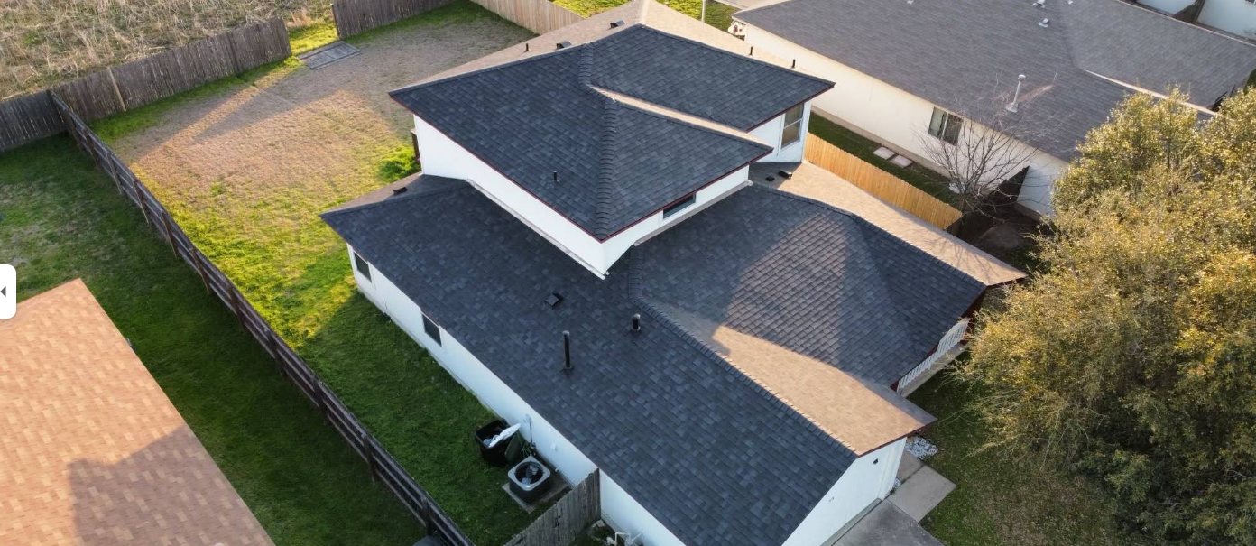 An aerial view of a house with a broken roof.