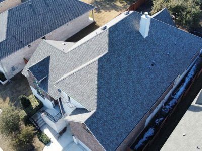 An aerial view of a house with a new roof.