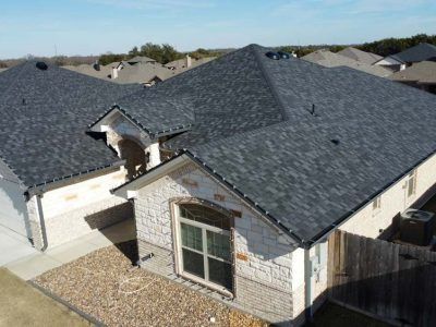 An aerial view of a house with a new roof.