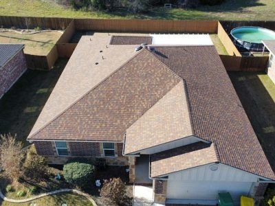 An aerial view of a house with a new roof.