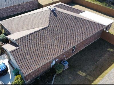 An aerial view of a house with a brown roof