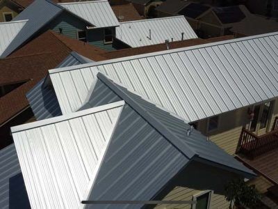 An aerial view of a house with a metal roof