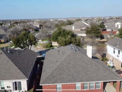 An aerial view of a residential area with houses and roofs.