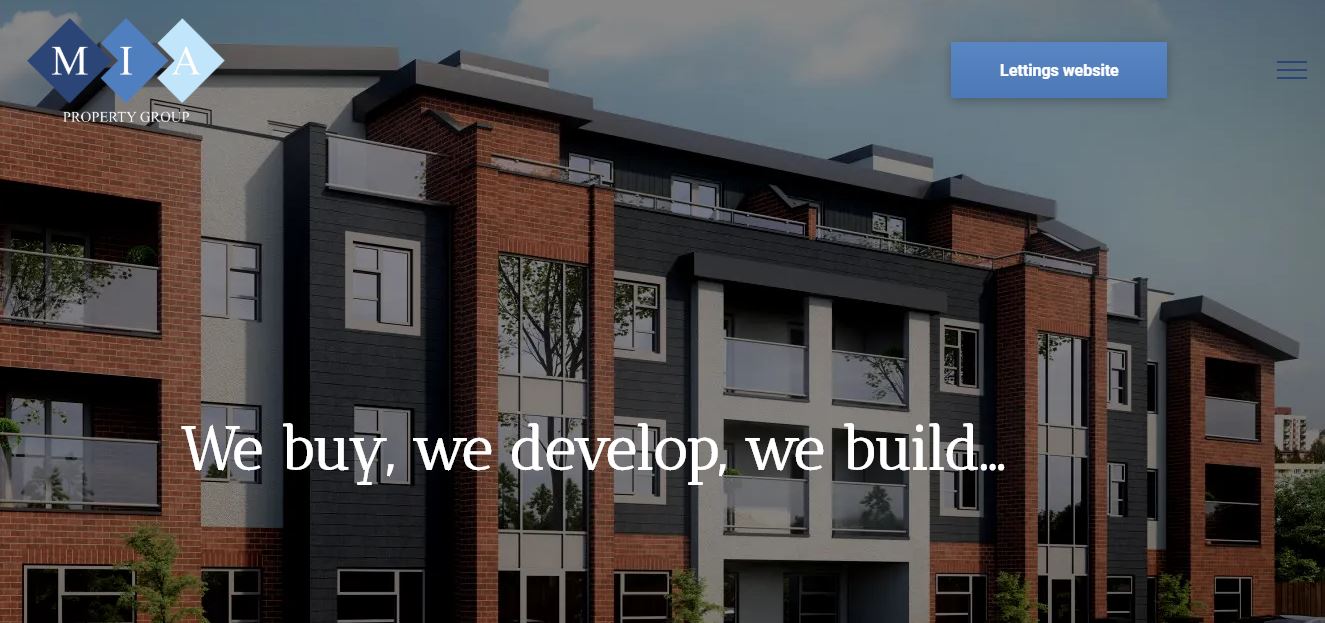 A building with the words we buy we develop we build on it