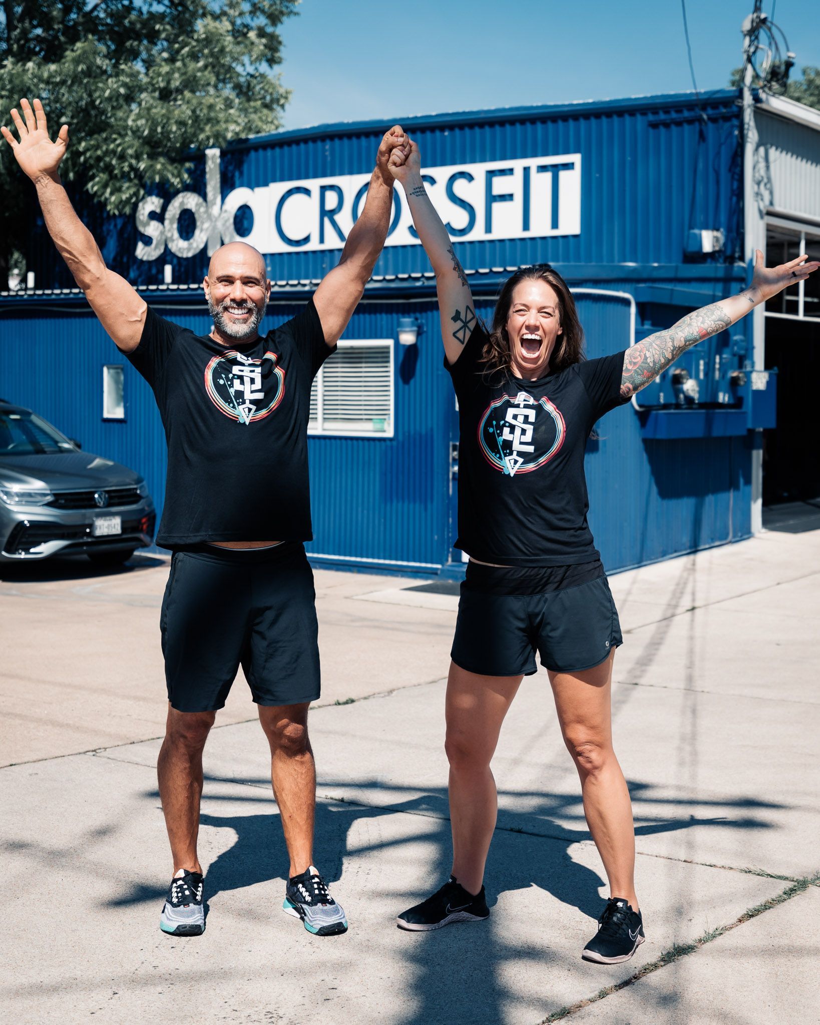 A man wearing a red shirt that says hard work is clapping his hands.