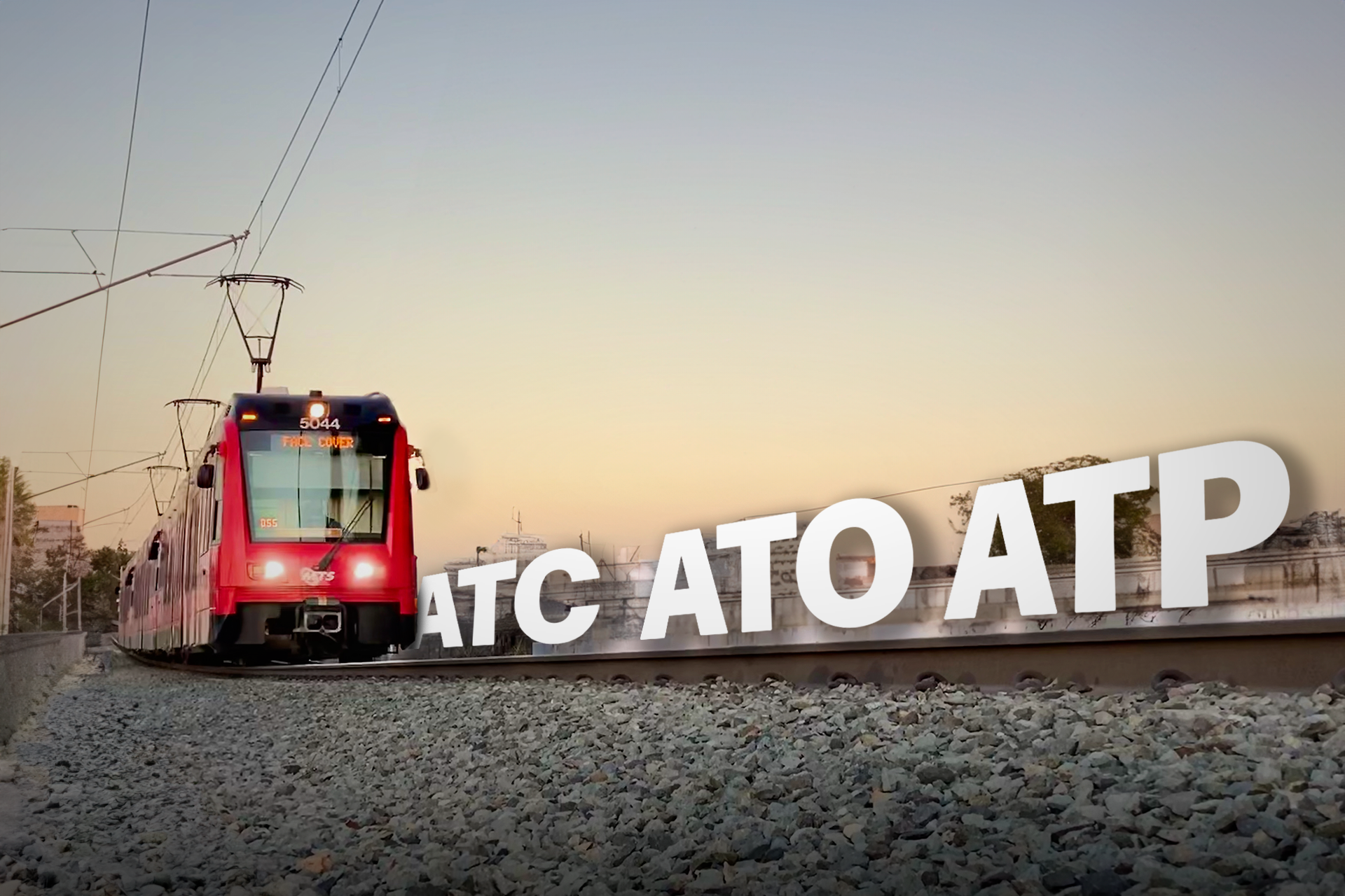 A red train is going down the tracks next to a sign that says atc ato atp