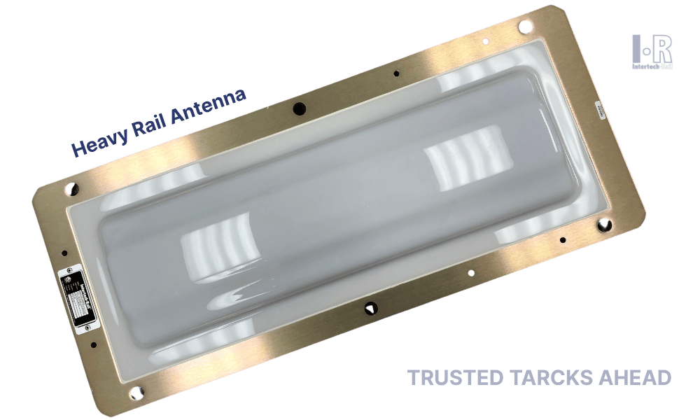 Heavy rail antenna, rectangular with silver frame and gray center, mounted on a surface.