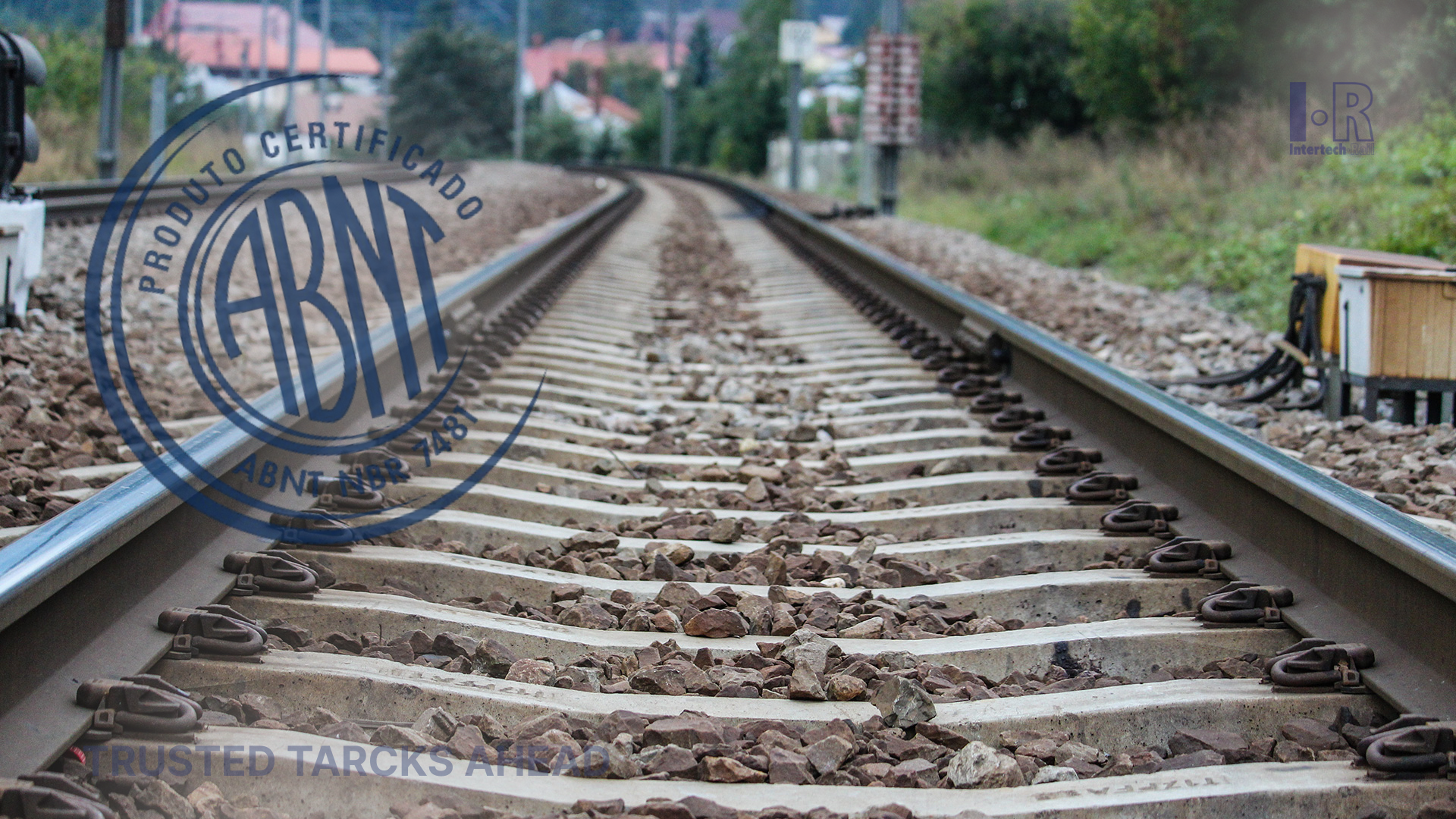 A close up of a train track with a stamp in the background.