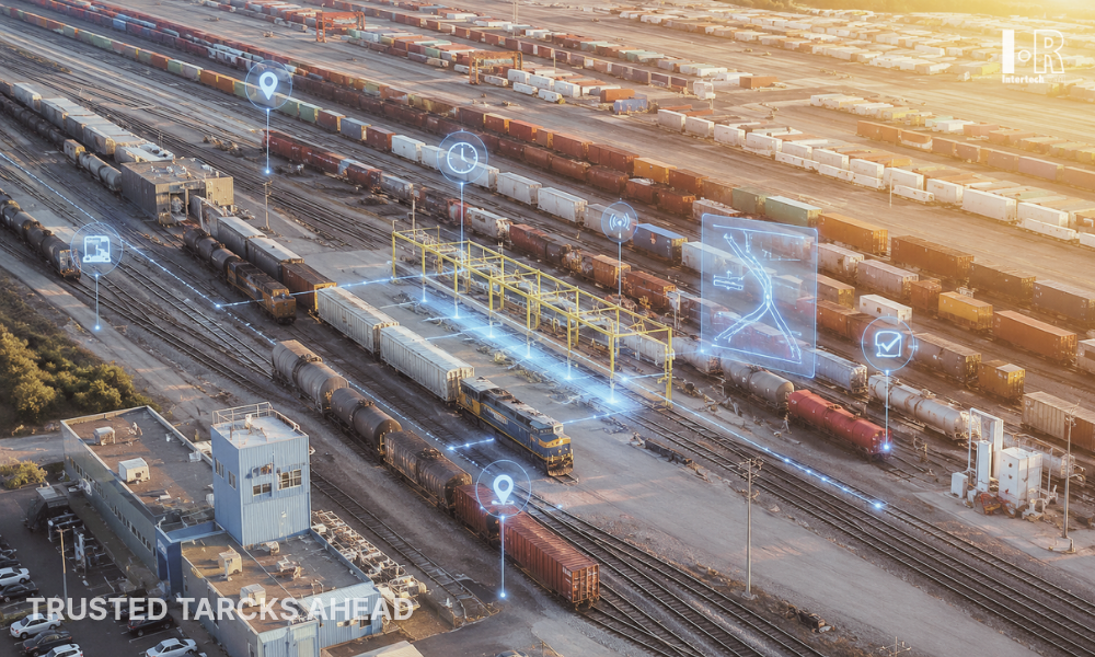 Rail yard with rows of freight trains and glowing digital icons overlaid above the tracks at sunrise