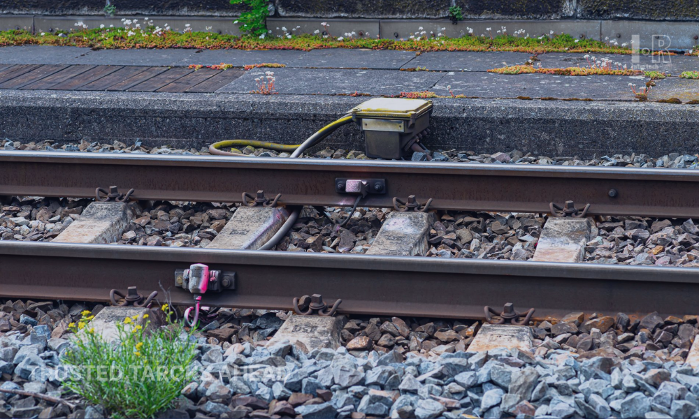 A wheel sensor is installed on a railway track for train detection and positioning systems
