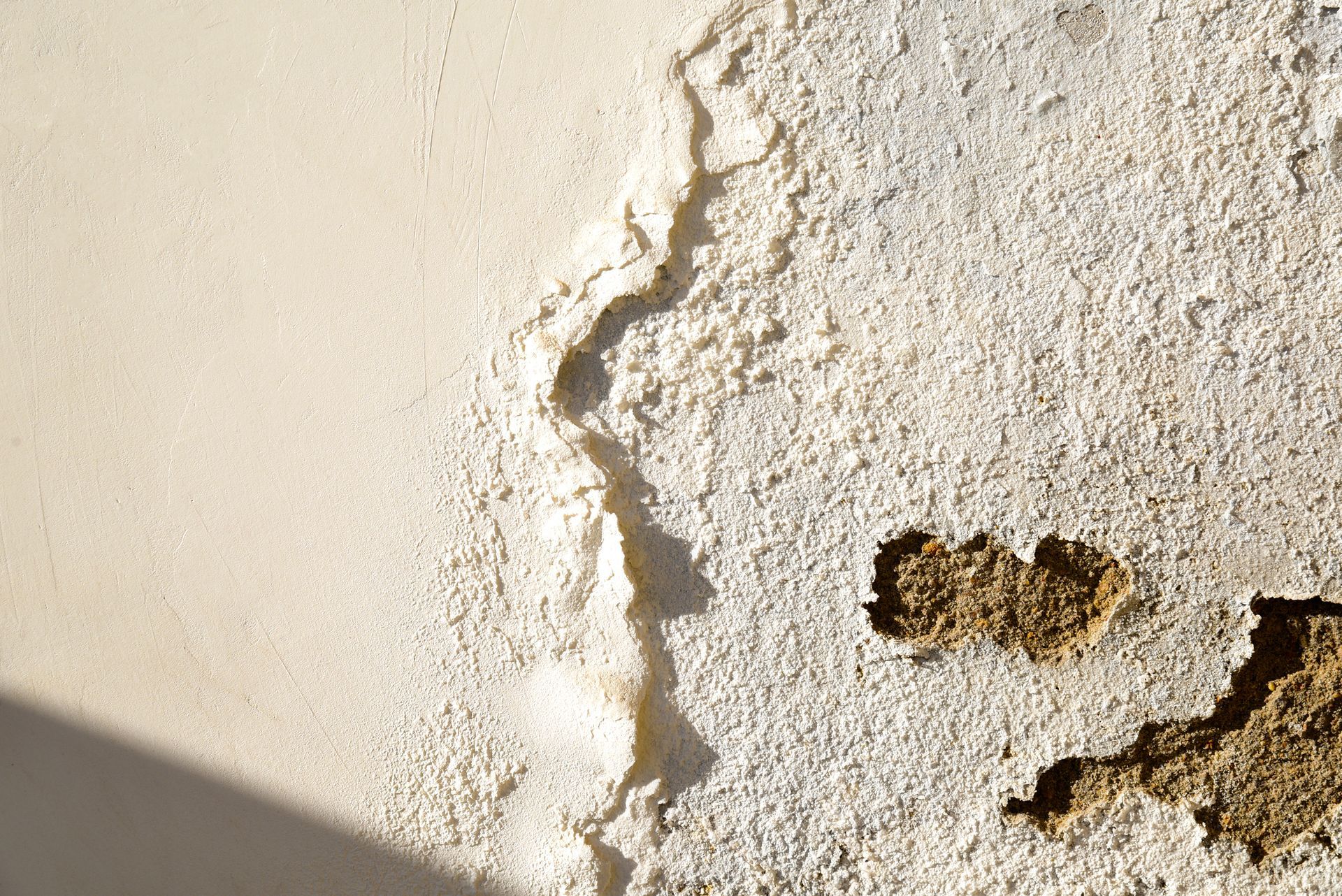 A close up of a white wall with a hole in it.