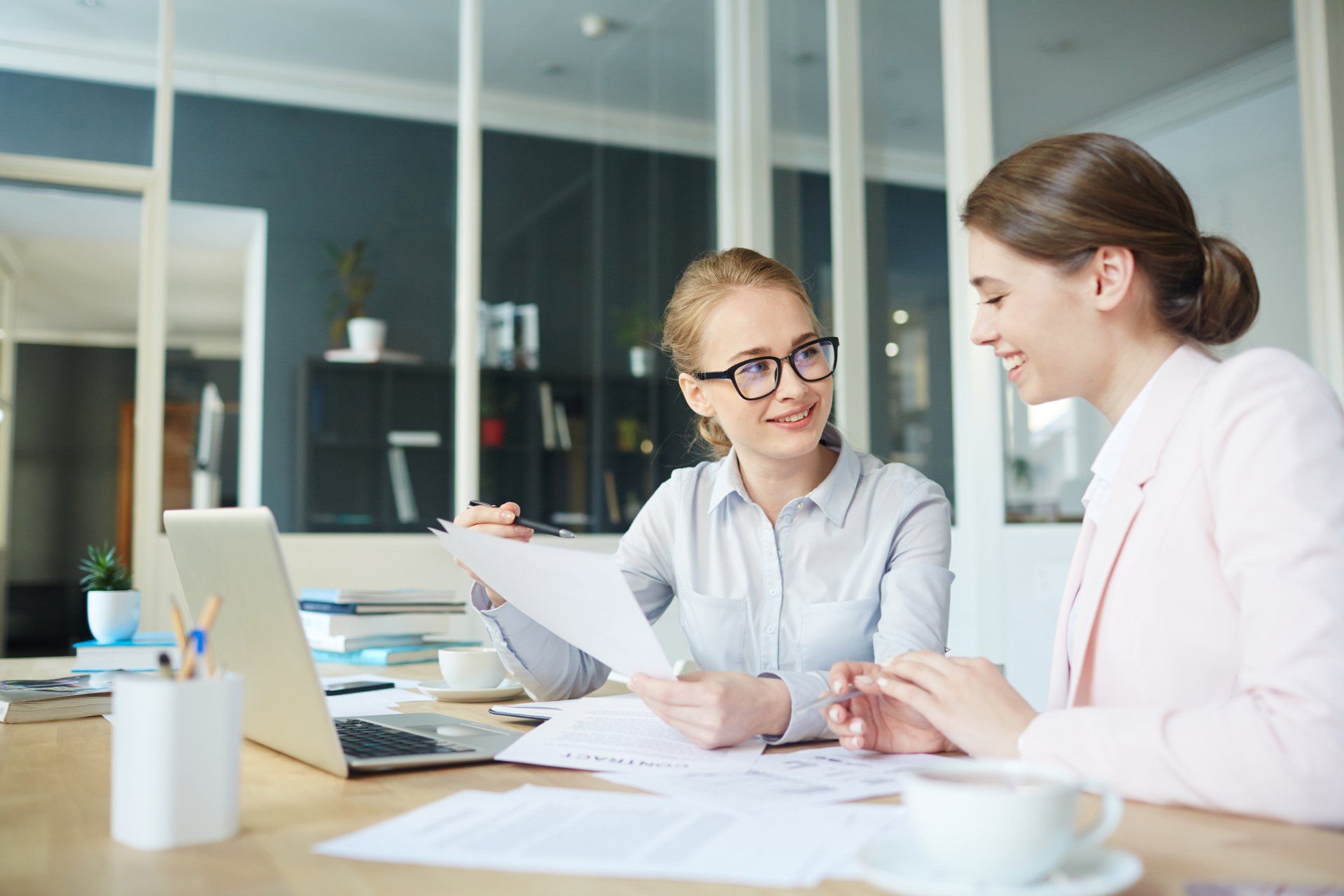 One of accountants showing paper with points of project to colleague