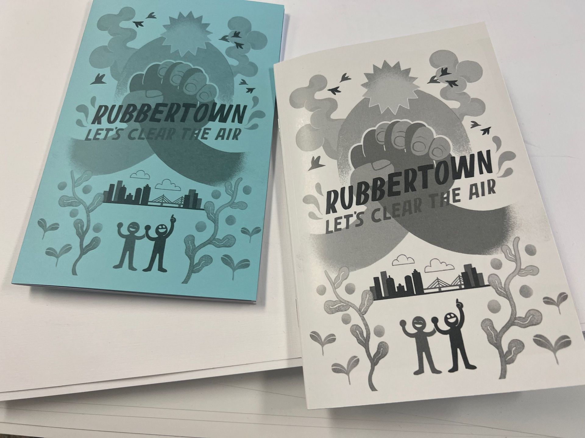 Two magazines side by side, one blue, one white, with two holding hands behind the title