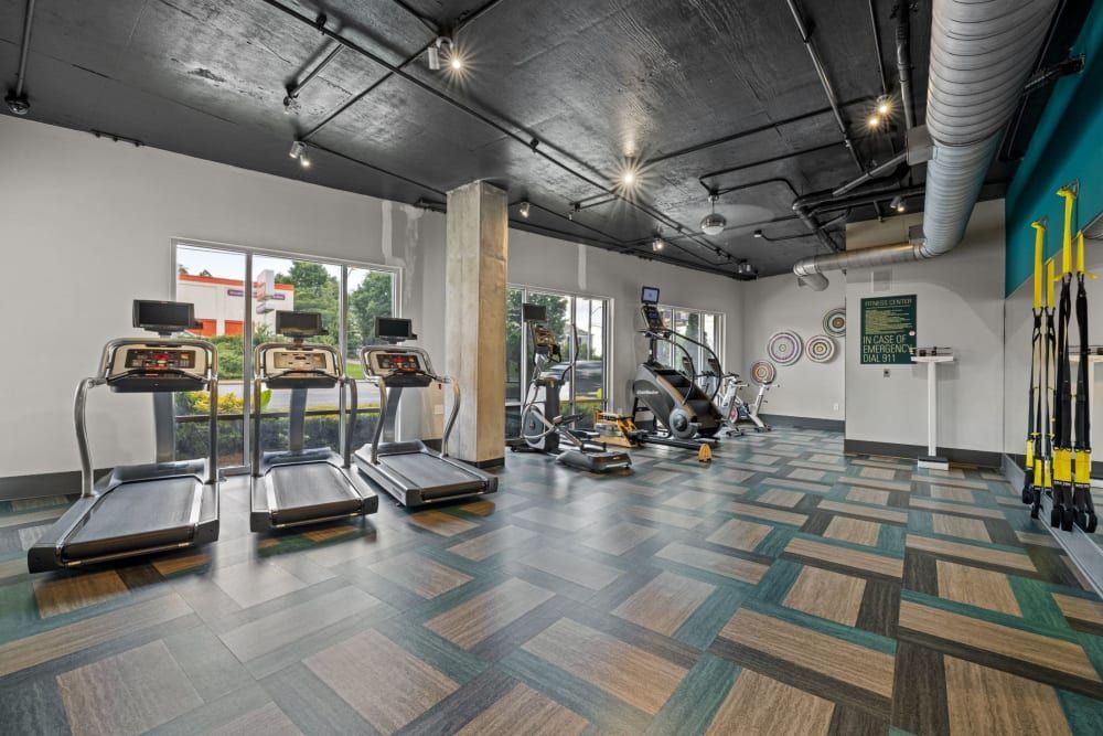 A fitness center with treadmills, exercise bikes, and other equipment at Skyline West in Atlanta, GA.