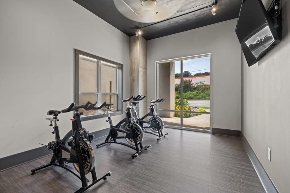 Indoor cycling room with outdoor view at Skyline West in Atlanta, GA.