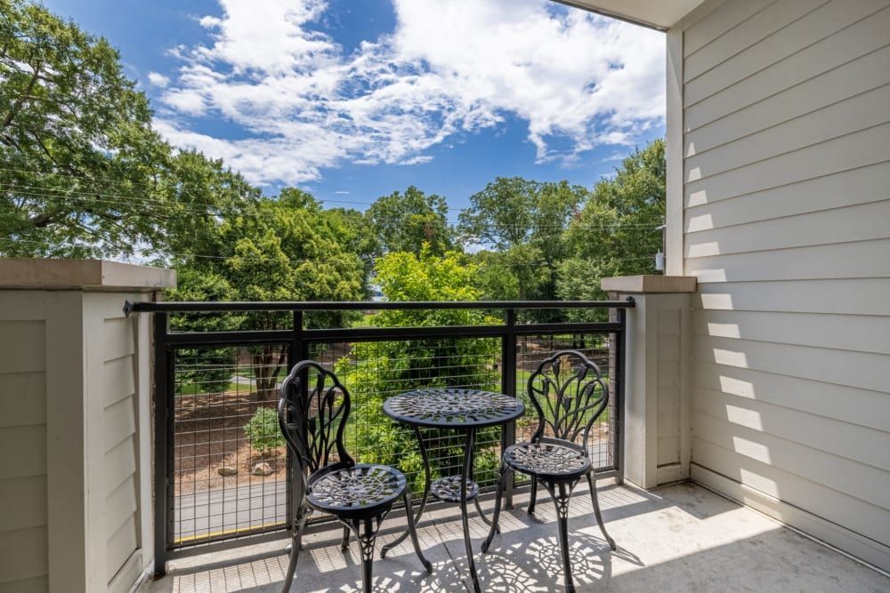 Apartment balcony with a table and chairs at Skyline West in Atlanta, GA.