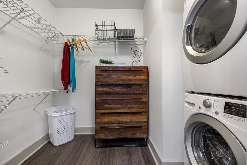 A laundry room with a washer and dryer stacked on top of each other at Skyline West in Atlanta, GA.
