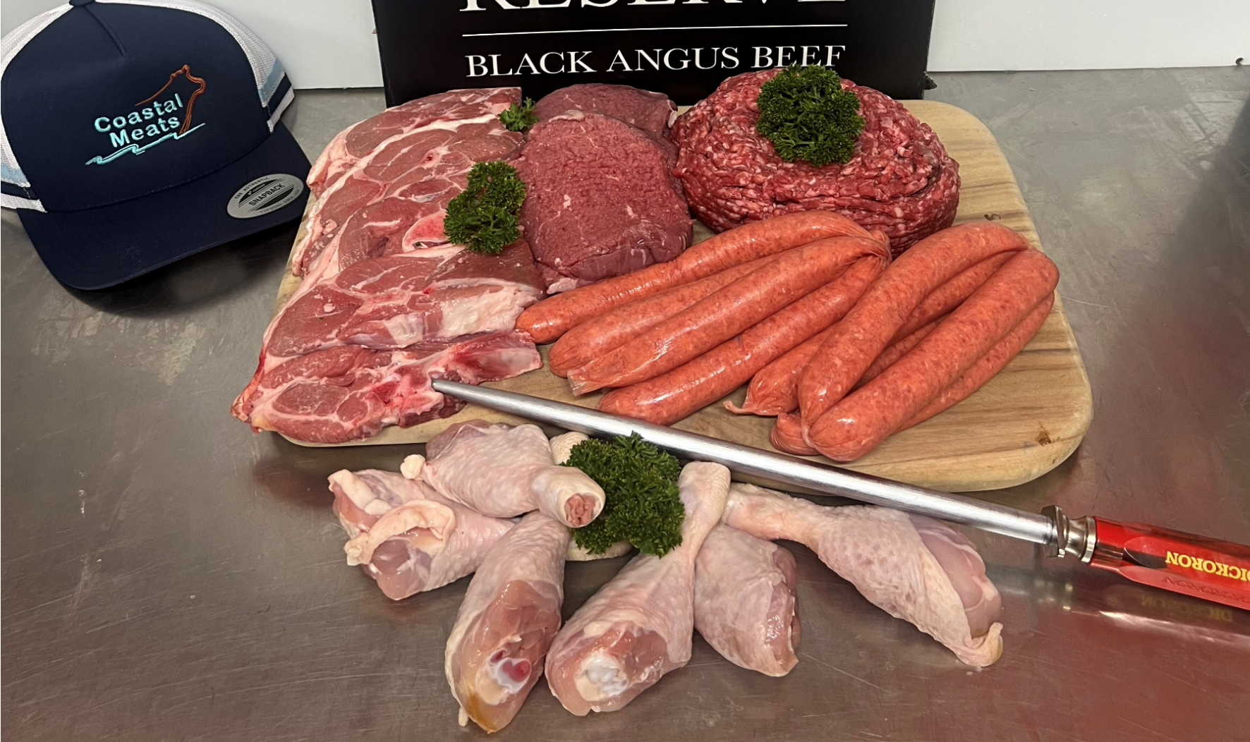 Various Cuts of Raw Meat Including Sausage, Ground Beef, and Chicken Pieces on a Wooden Board — Coastal Meats in Yeppoon, QLD