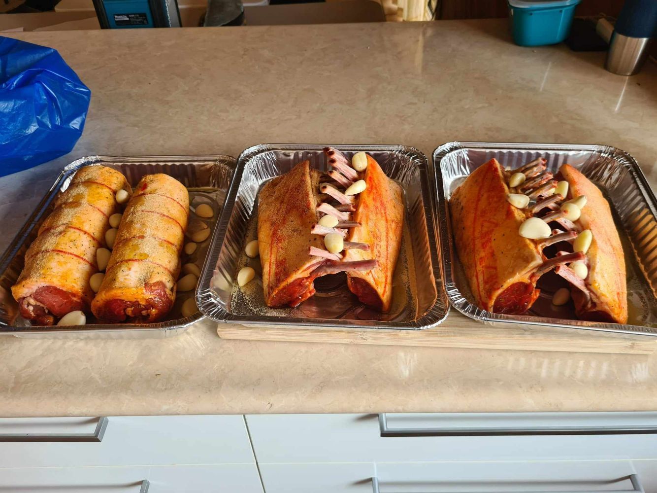 Three Trays of meat, Including one with Garlic, Displayed on a Counter — Coastal Meats in Yeppoon, QLD