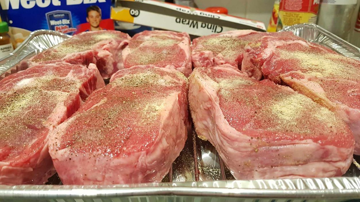 Premium Cuts of Meat Showcased in an Aluminium Foil Tray beside a Roll of Cling Film — Coastal Meats in Yeppoon, QLD