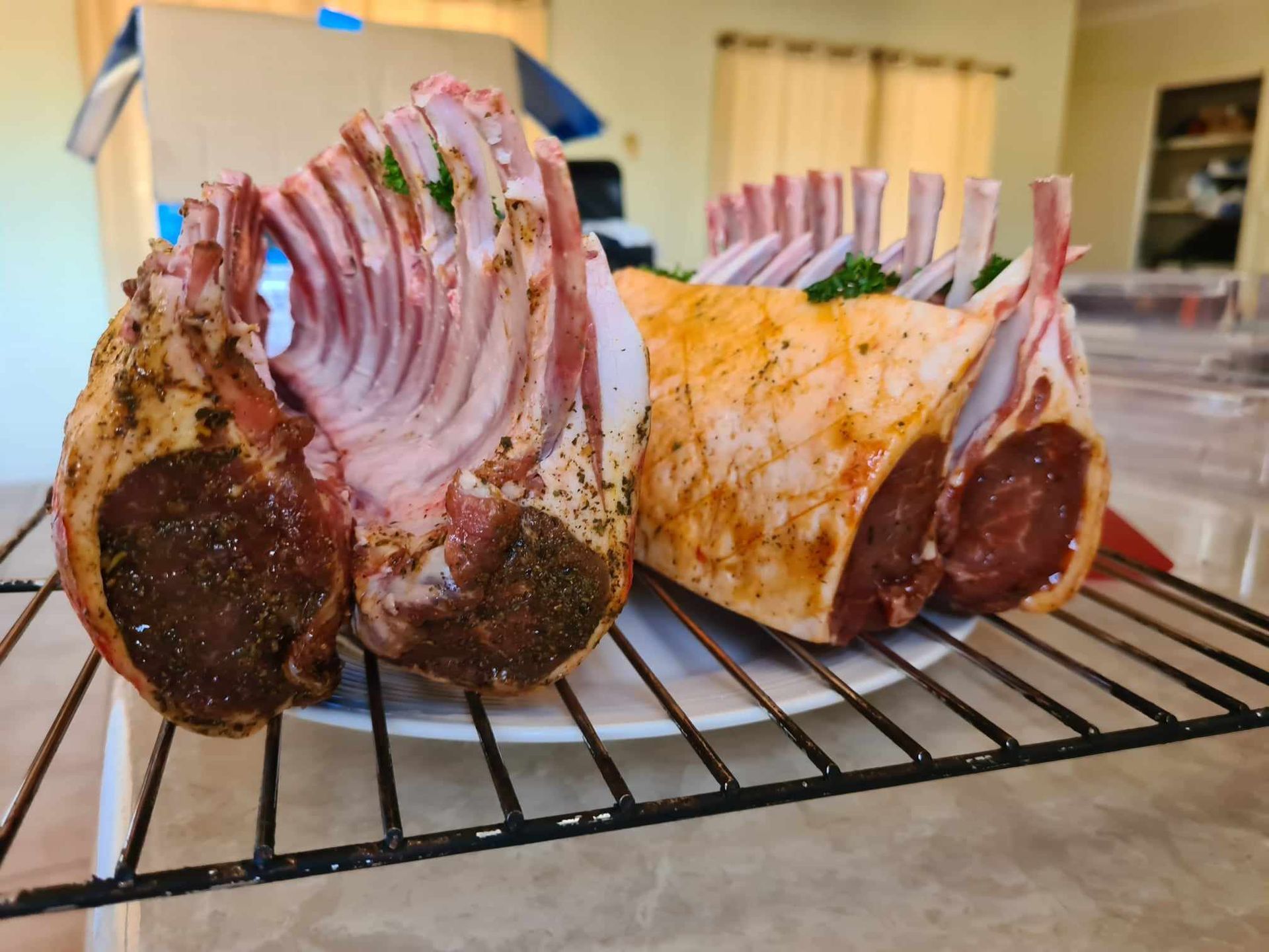 A Presentation of Lamb Chops Resting on a White Plate — Coastal Meats in Yeppoon, QLD