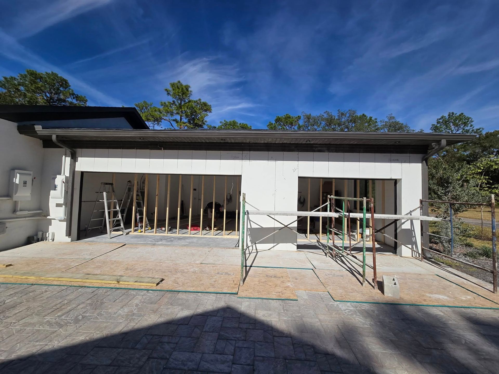 A house is being built with a garage under construction.