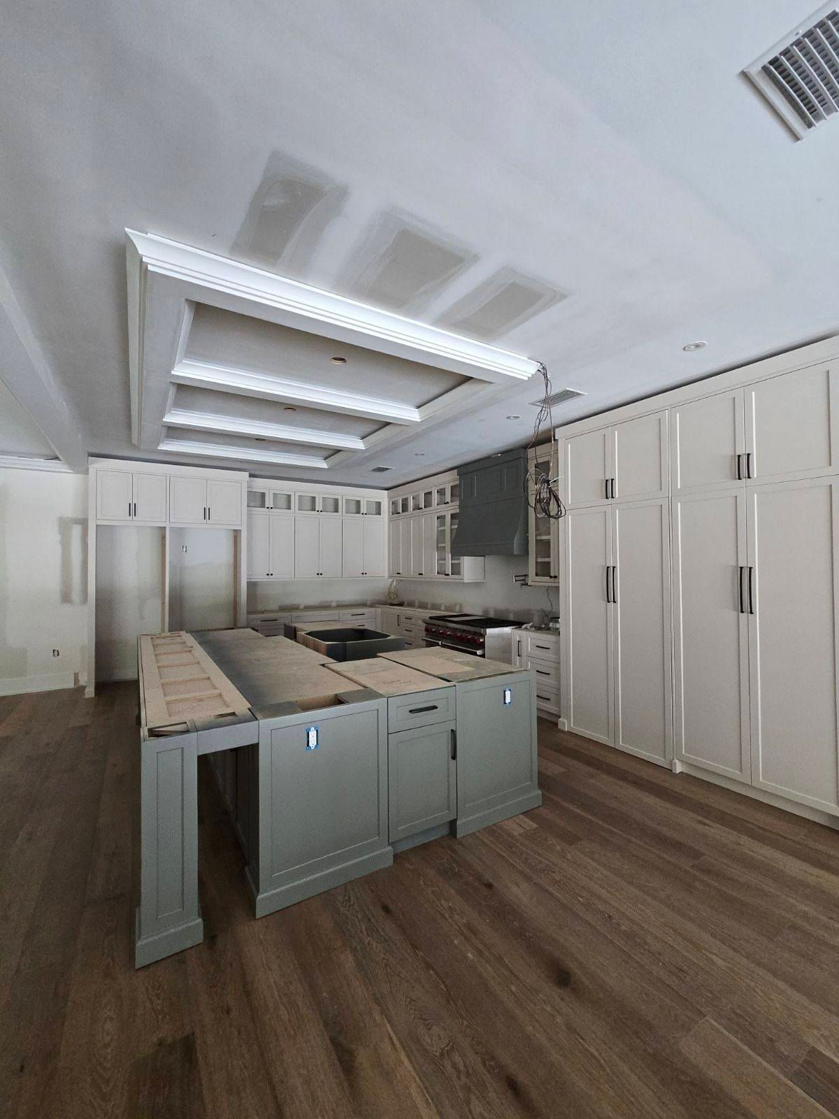 A kitchen with a large island in the middle of the room.