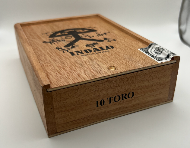 A stack of cigars sitting on top of a wooden table.