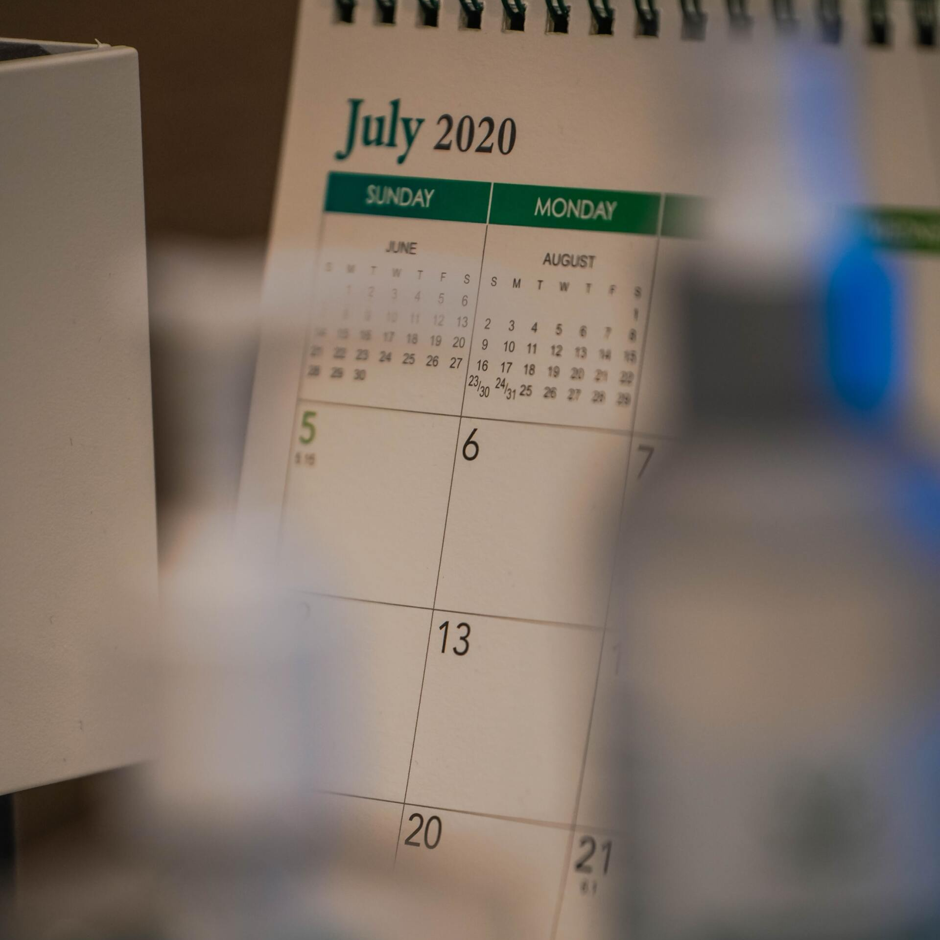 A calendar for july 2020 sits on a desk
