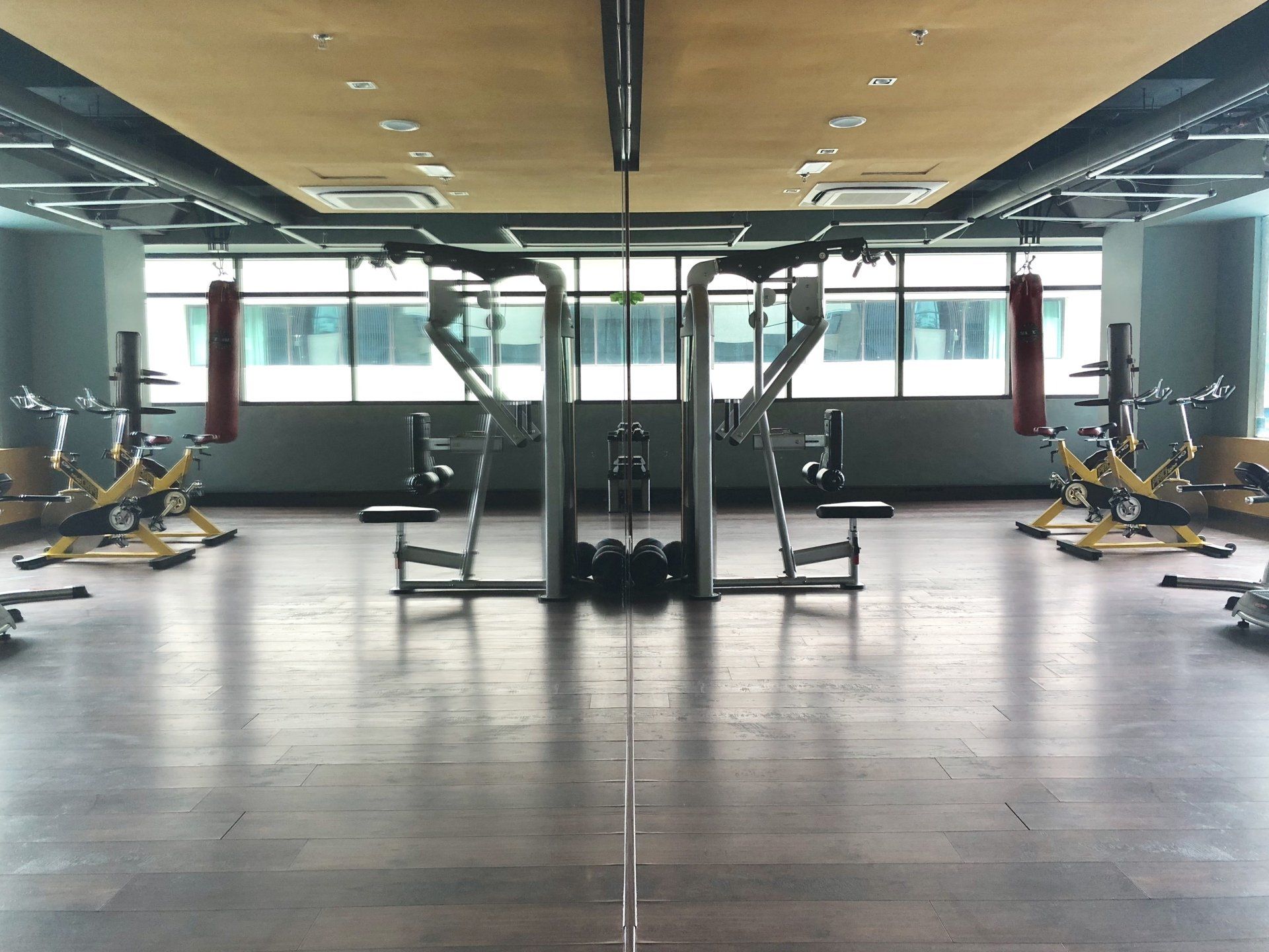 A gym with a lot of exercise equipment and a mirror