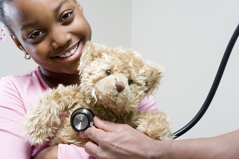 Girl holding teddy bar with stethoscope